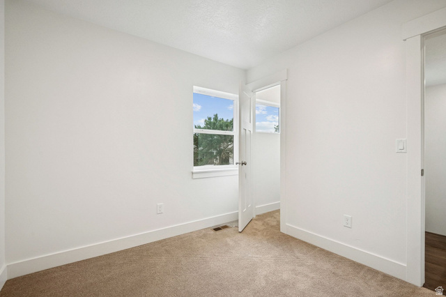 1627 North Angel Street Layton, UT 84041 - Photo 5 of 39 Unfurnished bedroom with baseboards and light carpet
