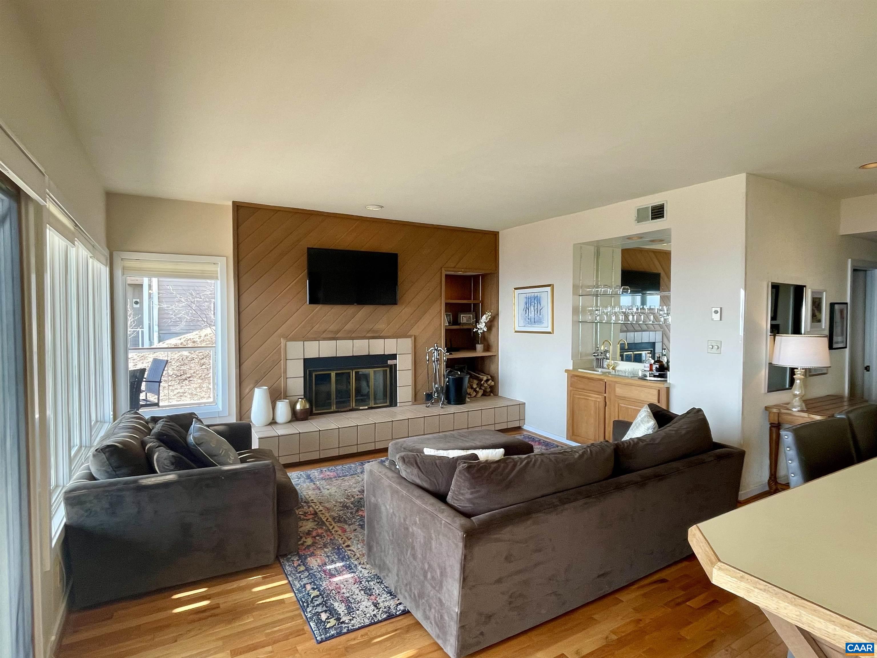 1613 Overlook Condos Roseland, VA 22967 - Photo 11 of 35 a living room with fireplace furniture and a flat screen tv