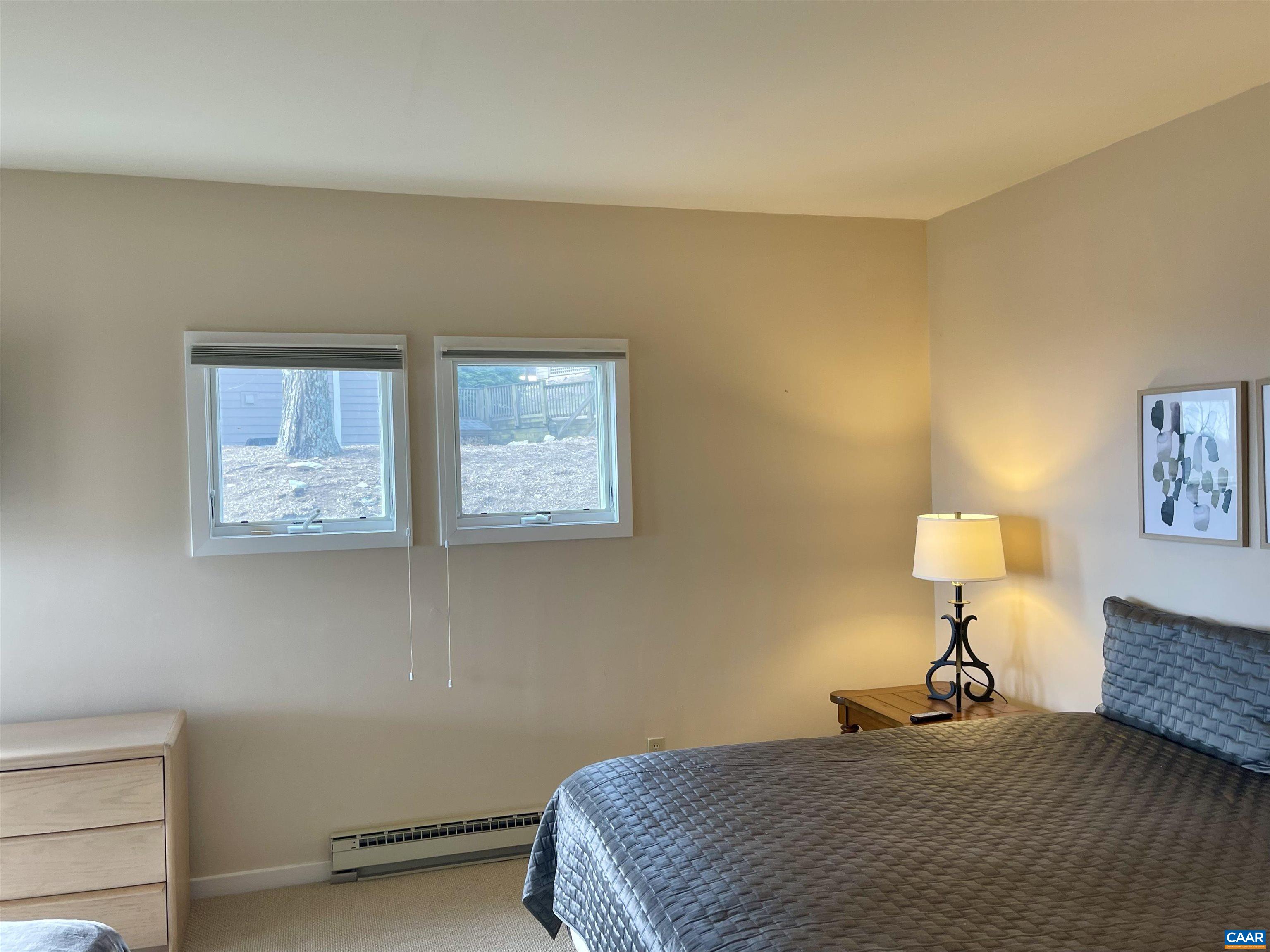 1613 Overlook Condos Roseland, VA 22967 - Photo 22 of 35 a bedroom with a bed and a lamp on table