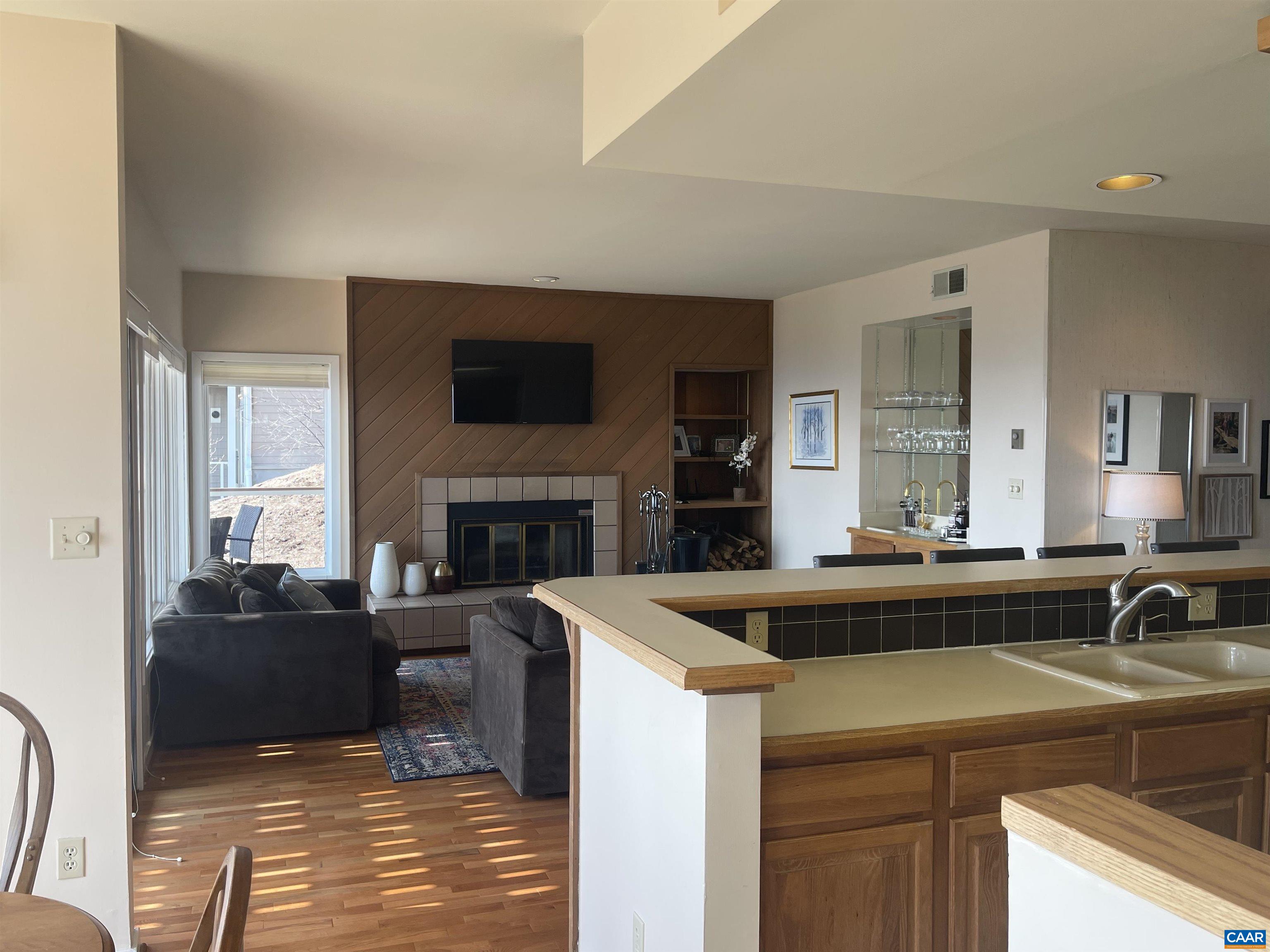 1613 Overlook Condos Roseland, VA 22967 - Photo 7 of 35 a view of kitchen island a sink and a stove top oven with wooden floor