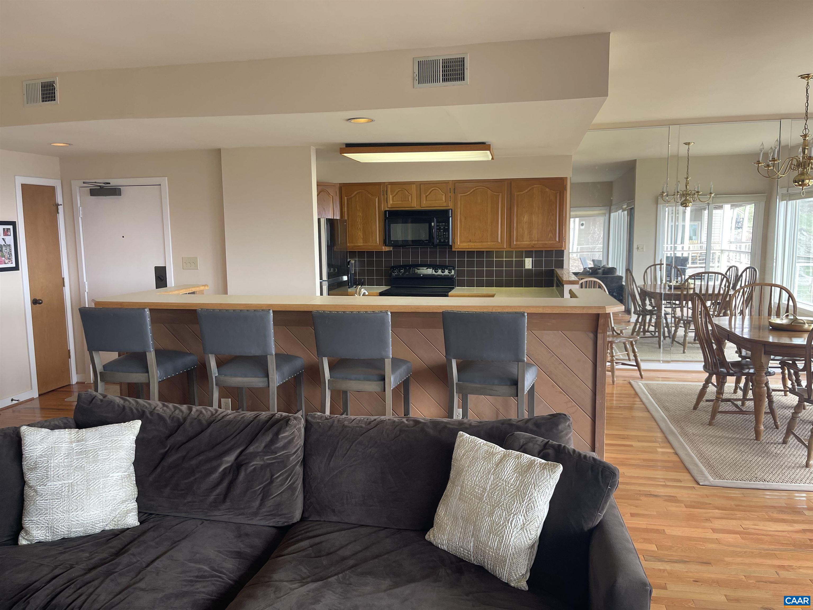 1613 Overlook Condos Roseland, VA 22967 - Photo 8 of 35 a living room with furniture and a dining table with kitchen view