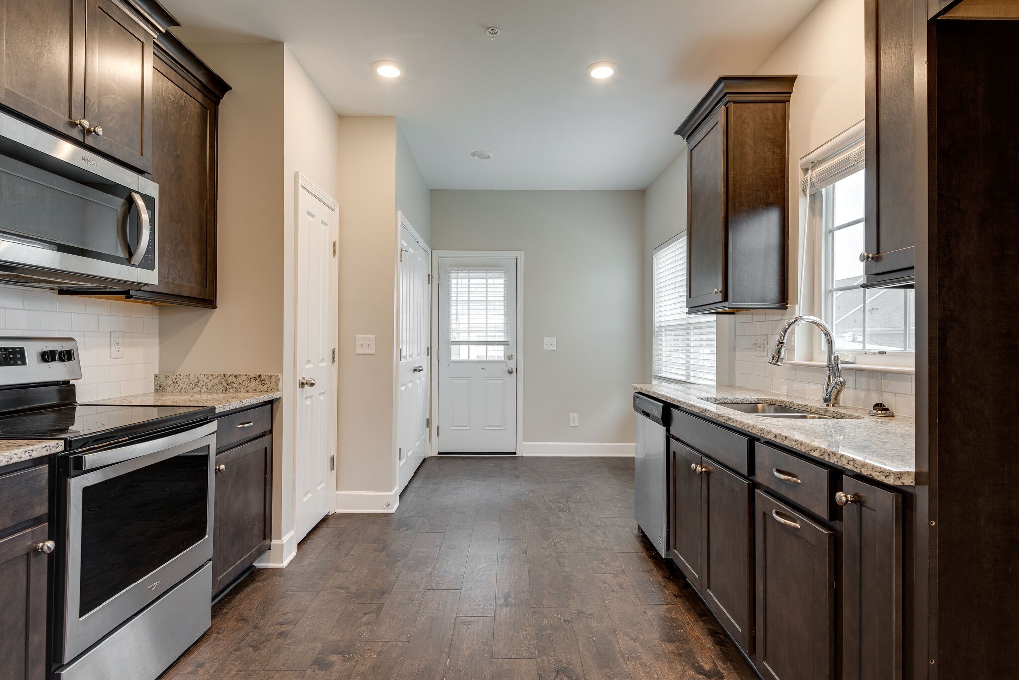 269 Mary Ann Circle Spring Hill, TN 37174 - Photo 7 of 28 a kitchen with stainless steel appliances granite countertop a stove a sink and a microwave