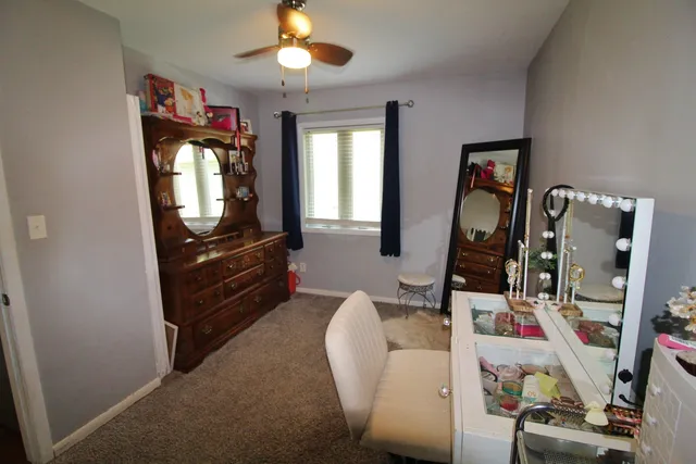 a living room with furniture a flat screen tv and a window