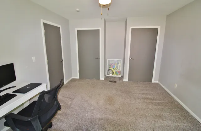 a view of a workspace with furniture and wooden floor