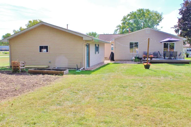 a view of a house with backyard and sitting area