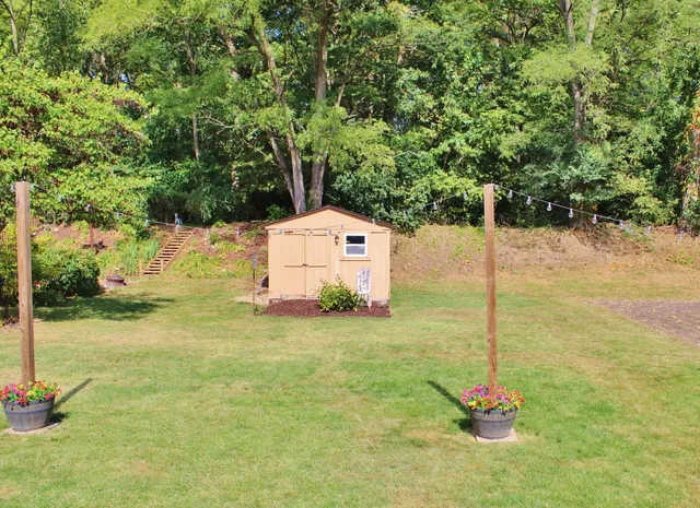 a house is sitting in middle of a field