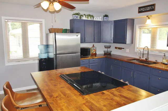 a kitchen with wooden cabinets and refrigerator