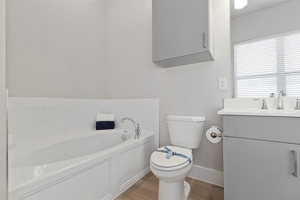 8218 Idyllic Place McKinney, TX 75071 - Photo 23 of 24 a white toilet sitting next to a bathroom sink