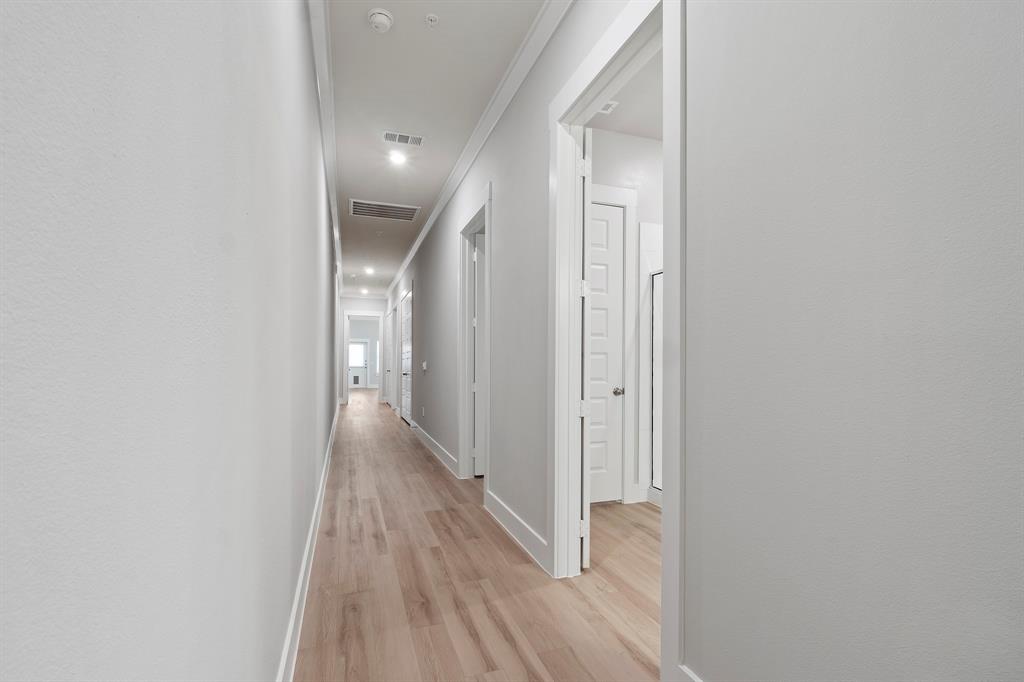 8218 Idyllic Place McKinney, TX 75071 - Photo 7 of 24 a view of hallway with wooden floor