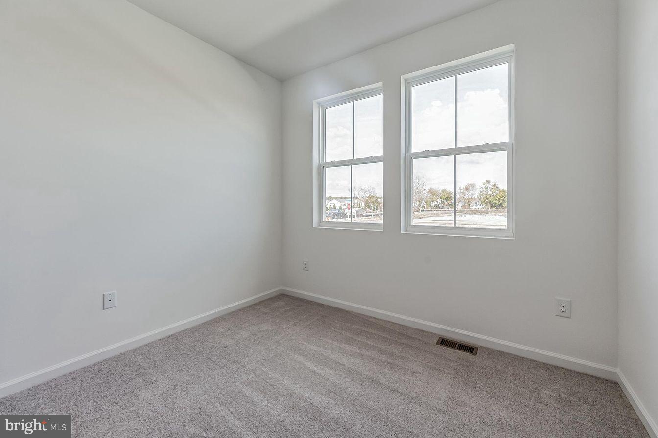 23506 Reed Grass Way Millville, DE 19970 - Photo 13 of 15 an empty room with a window