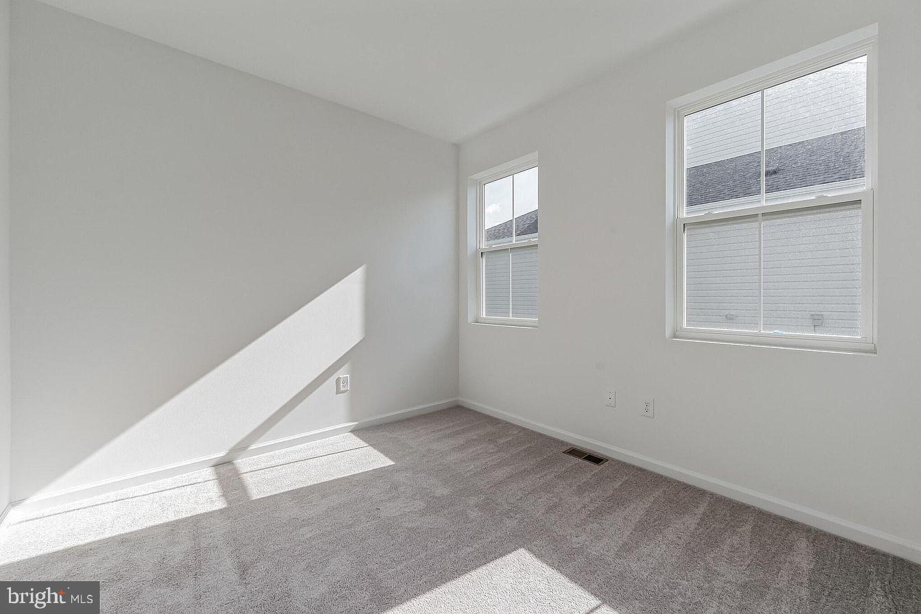 23506 Reed Grass Way Millville, DE 19970 - Photo 14 of 15 an empty room with windows