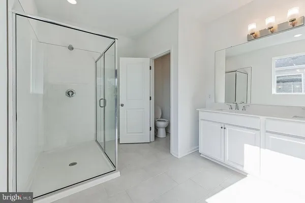a bathroom with a shower sink and mirror
