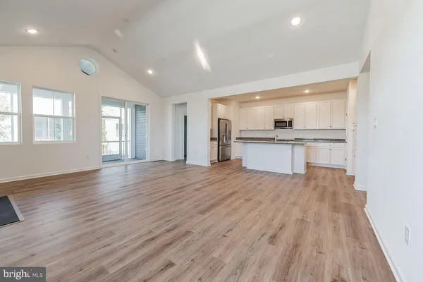 a view of a kitchen with a sink and a refrigerator