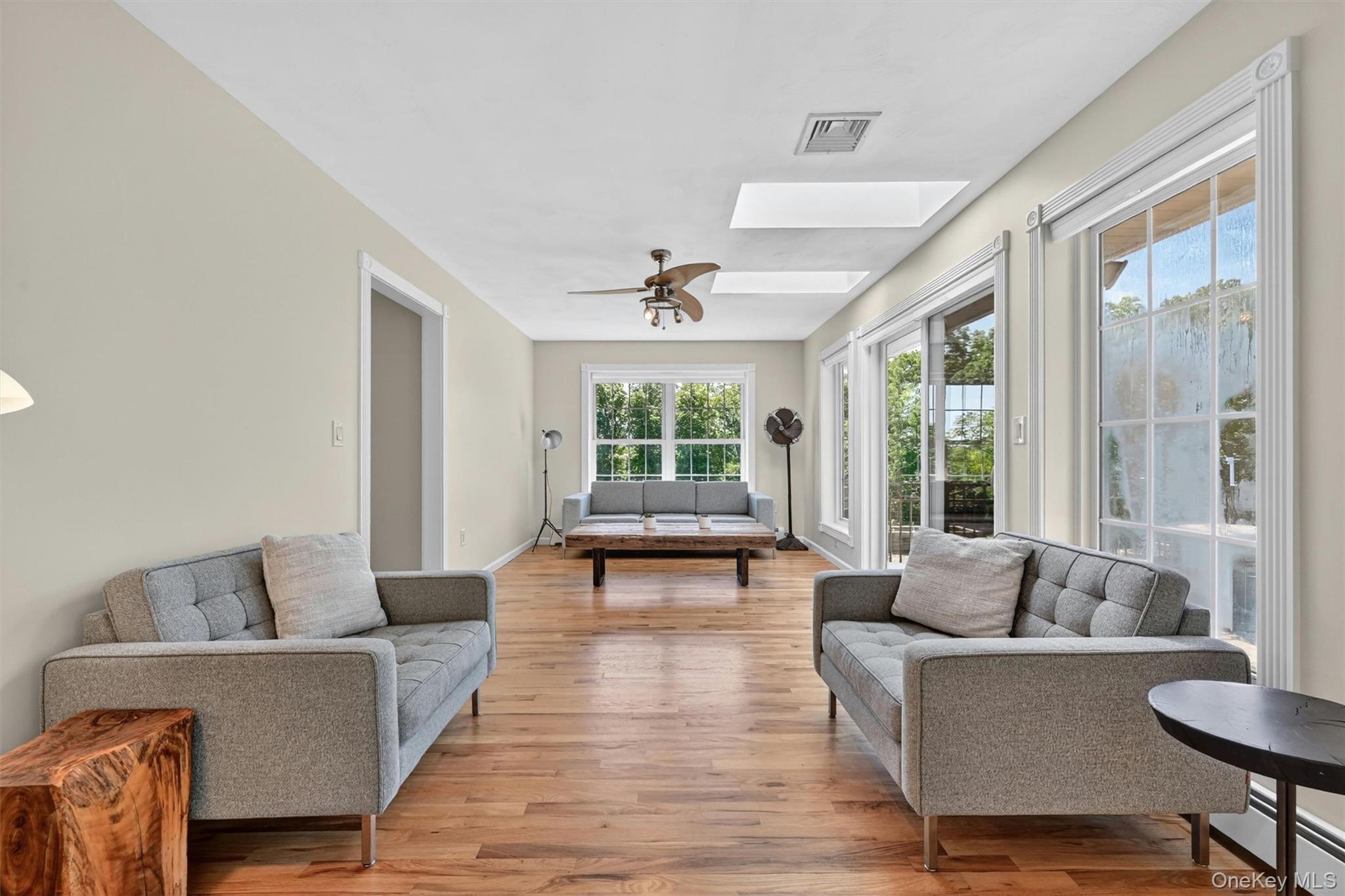954 Ridgebury Road New Hampton, NY 10958 - Photo 14 of 45 A slightly different angle of this sun-filled family room. A calm and welcoming space, with skylights, beautifully refinished hardwood floors, and windows that draw your eye toward the outdoor living space.