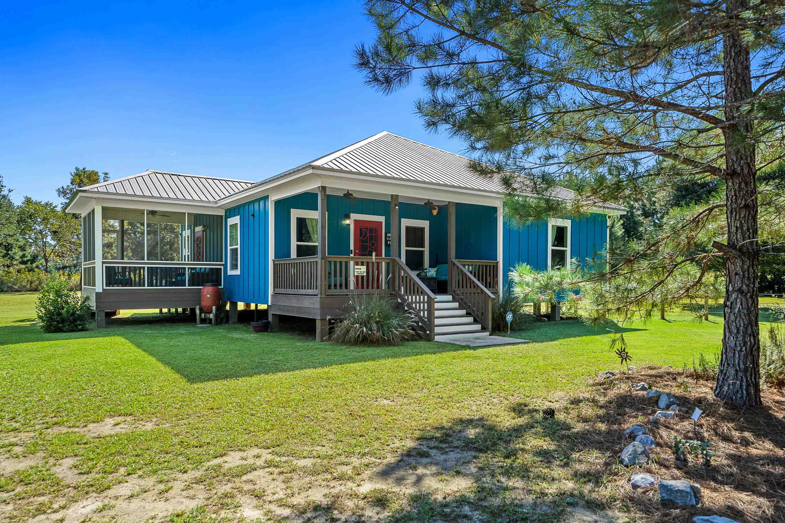 24616 Bretz Lane Elberta, AL 36530 - Photo 1 of 42 Certified FORTIFIED Silver Home (IBHS 2025) with open front porch and screened side porch.