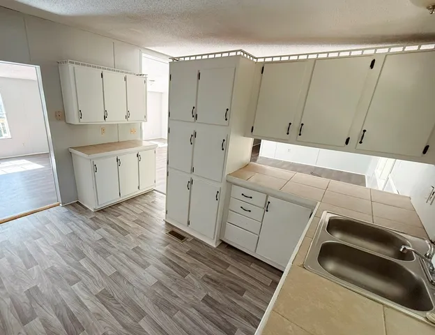 a utility room with cabinets washer and dryer