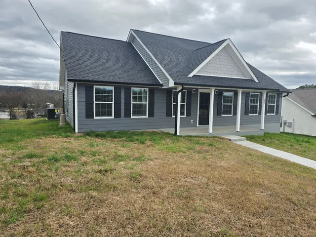 a front view of a house with a garden