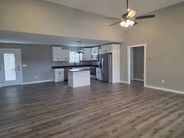a view of kitchen with sink and wooden floor