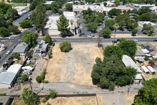 an aerial view of a house with a yard and lake view
