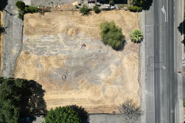 an aerial view of residential houses with outdoor space