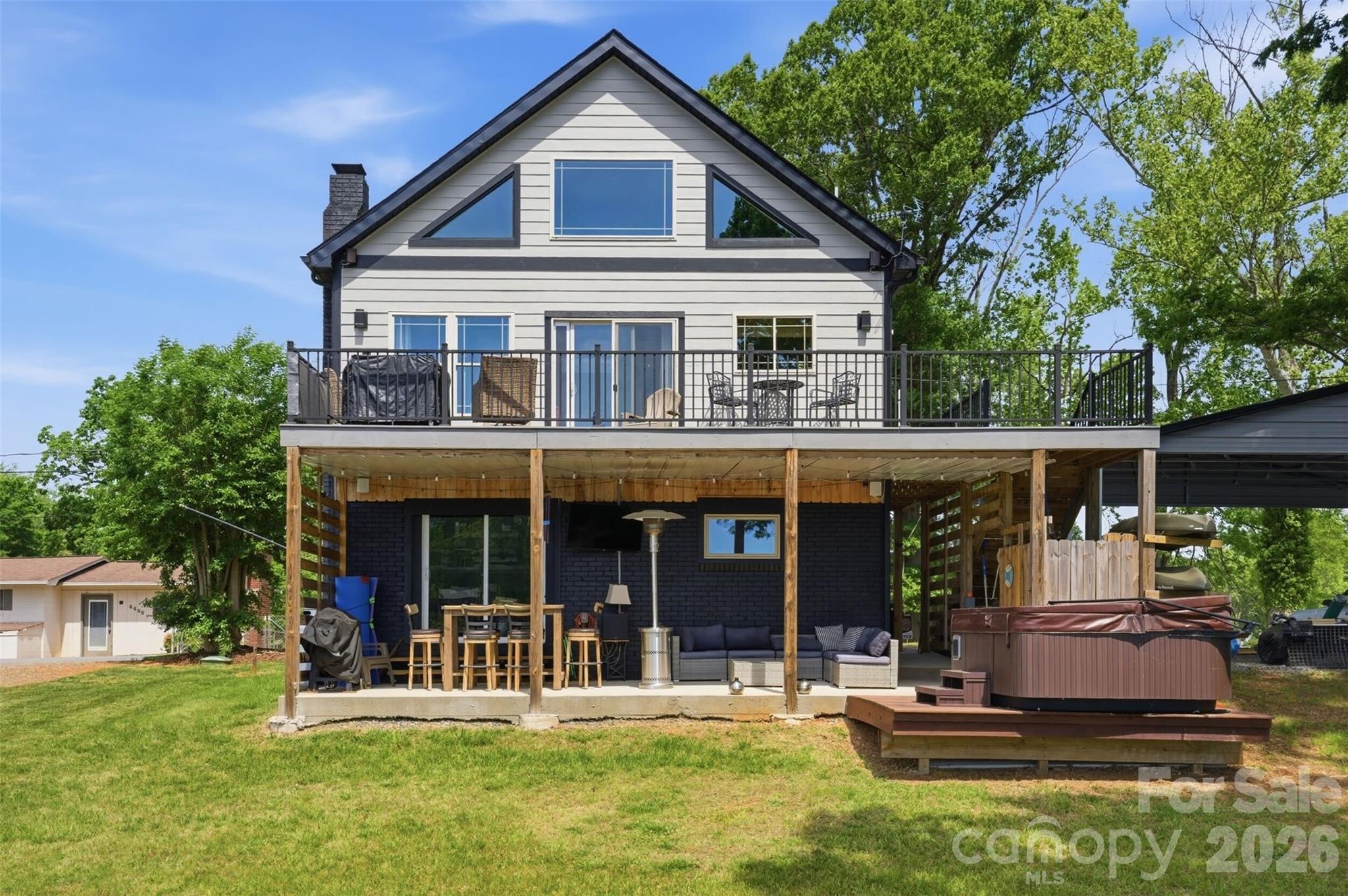 4473 Ridge Street Claremont, NC 28610 - Photo 2 of 26 a front view of a house with a yard table and chairs