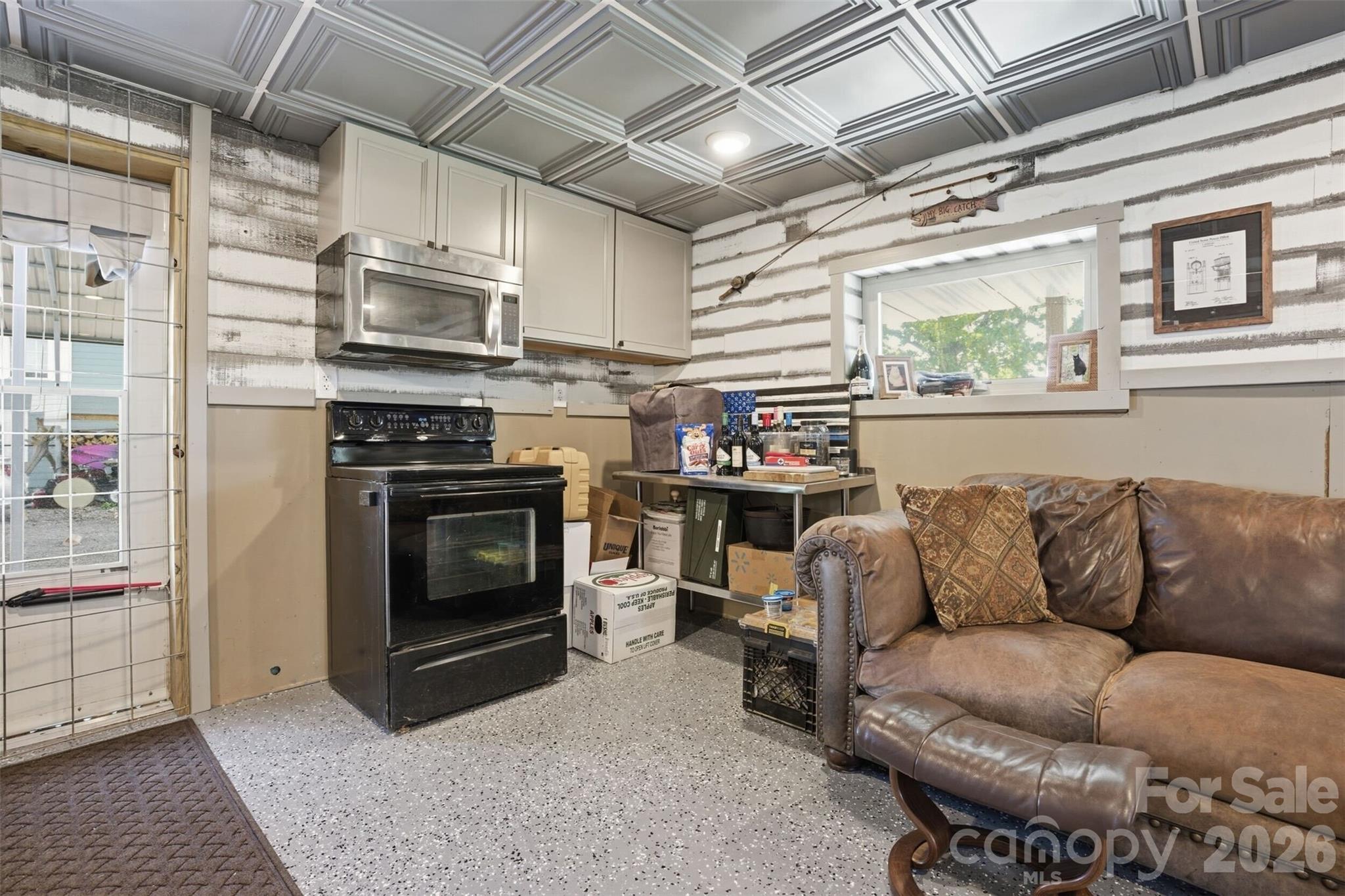 4473 Ridge Street Claremont, NC 28610 - Photo 22 of 26 a living room with furniture a flat screen tv and a fireplace
