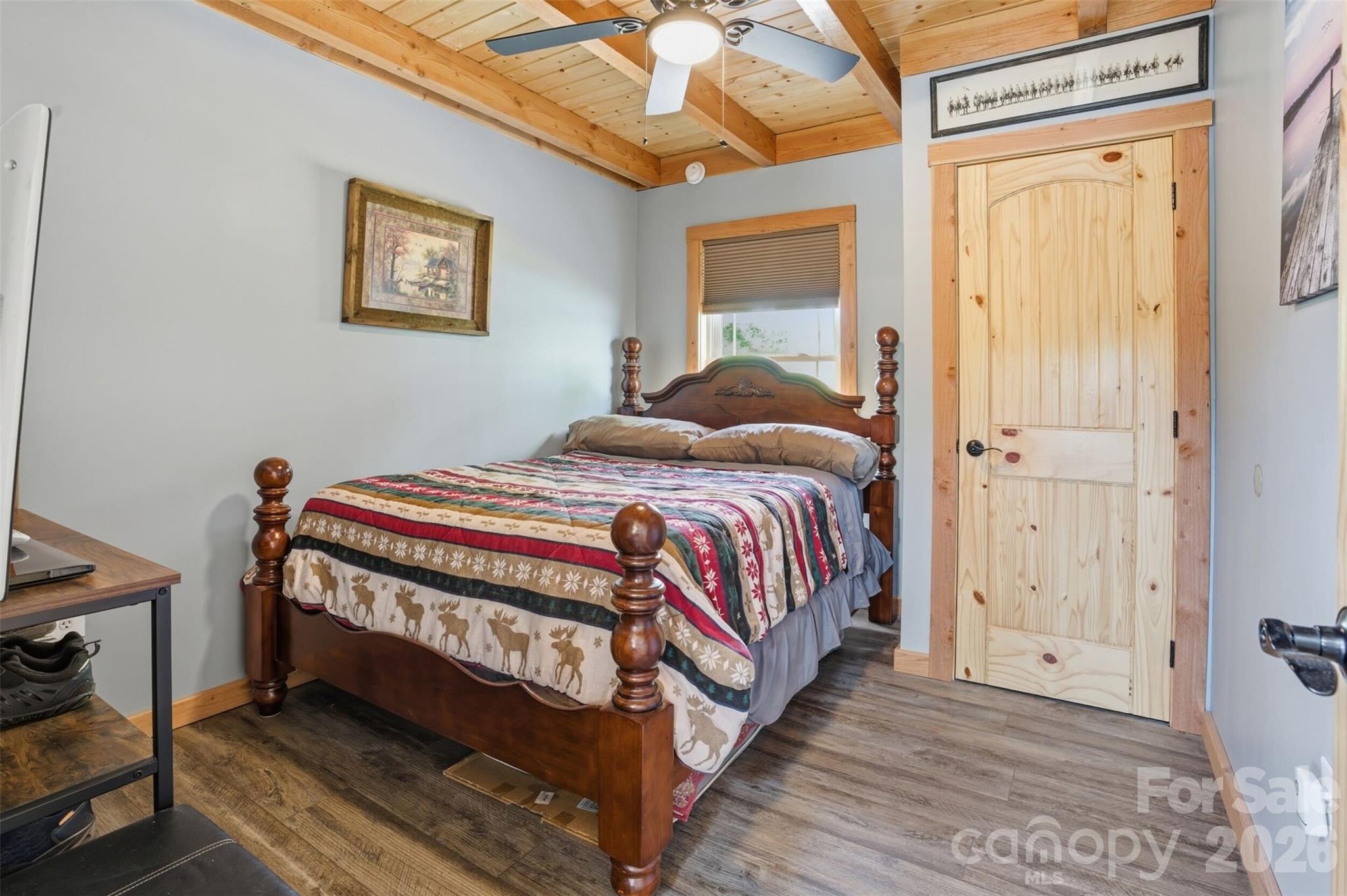 4473 Ridge Street Claremont, NC 28610 - Photo 10 of 26 a bedroom with a bed and wooden floor