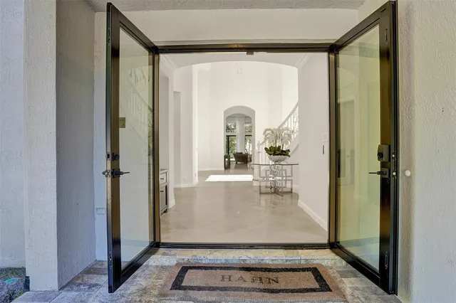 a dining room with furniture and a floor to ceiling window