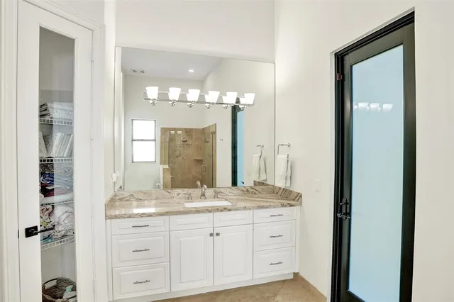 a bedroom with bed a couch and a large window