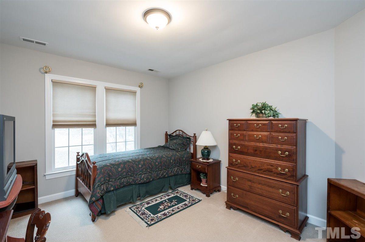 5704 Dunstan Court Raleigh, NC 27613 - Photo 16 of 23 a bedroom with a bed and a television