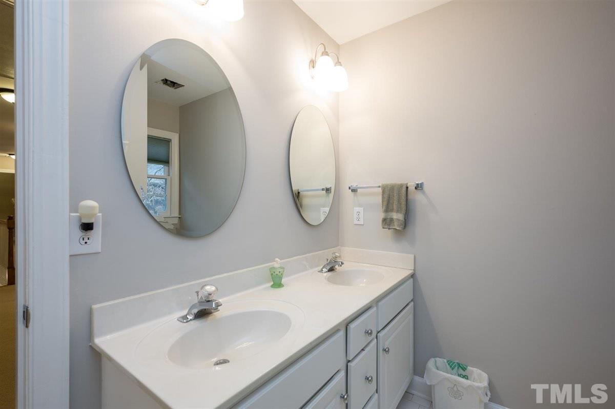 5704 Dunstan Court Raleigh, NC 27613 - Photo 18 of 23 a bathroom with a sink and a mirror