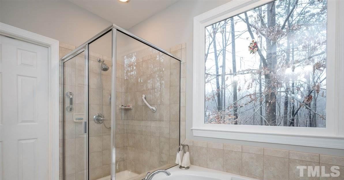 5704 Dunstan Court Raleigh, NC 27613 - Photo 20 of 23 a bathroom with a shower and a window