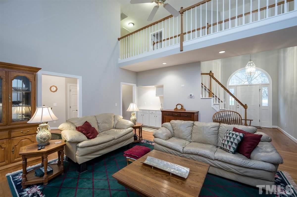 5704 Dunstan Court Raleigh, NC 27613 - Photo 3 of 23 a living room with furniture and a ceiling fan