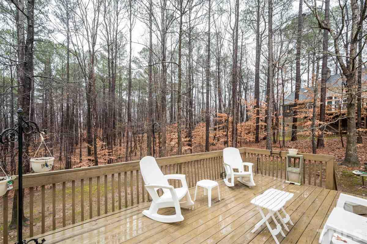 5704 Dunstan Court Raleigh, NC 27613 - Photo 22 of 23 a view of balcony with wooden floor and outdoor seating