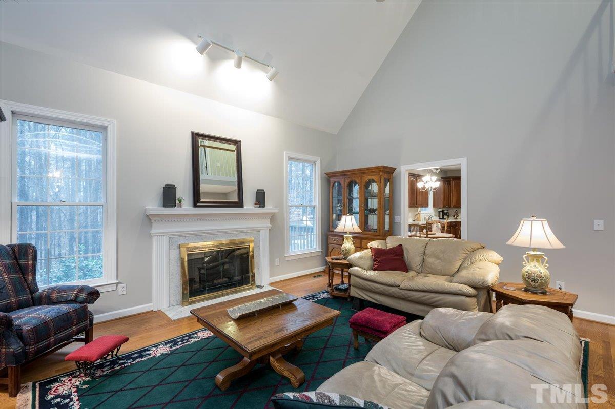 5704 Dunstan Court Raleigh, NC 27613 - Photo 4 of 23 a living room with furniture fireplace and flat screen tv