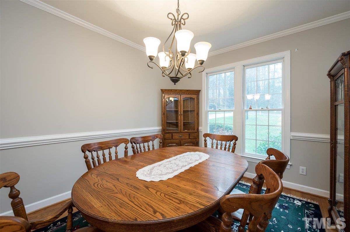 5704 Dunstan Court Raleigh, NC 27613 - Photo 5 of 23 a view of a dining room with furniture wooden floor and chandelier