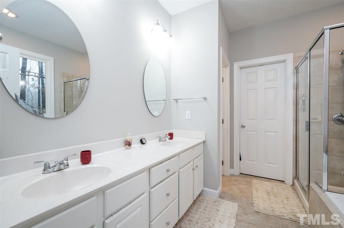 5704 Dunstan Court Raleigh, NC 27613 - Photo 8 of 23 a bathroom with a double vanity sink mirror and
