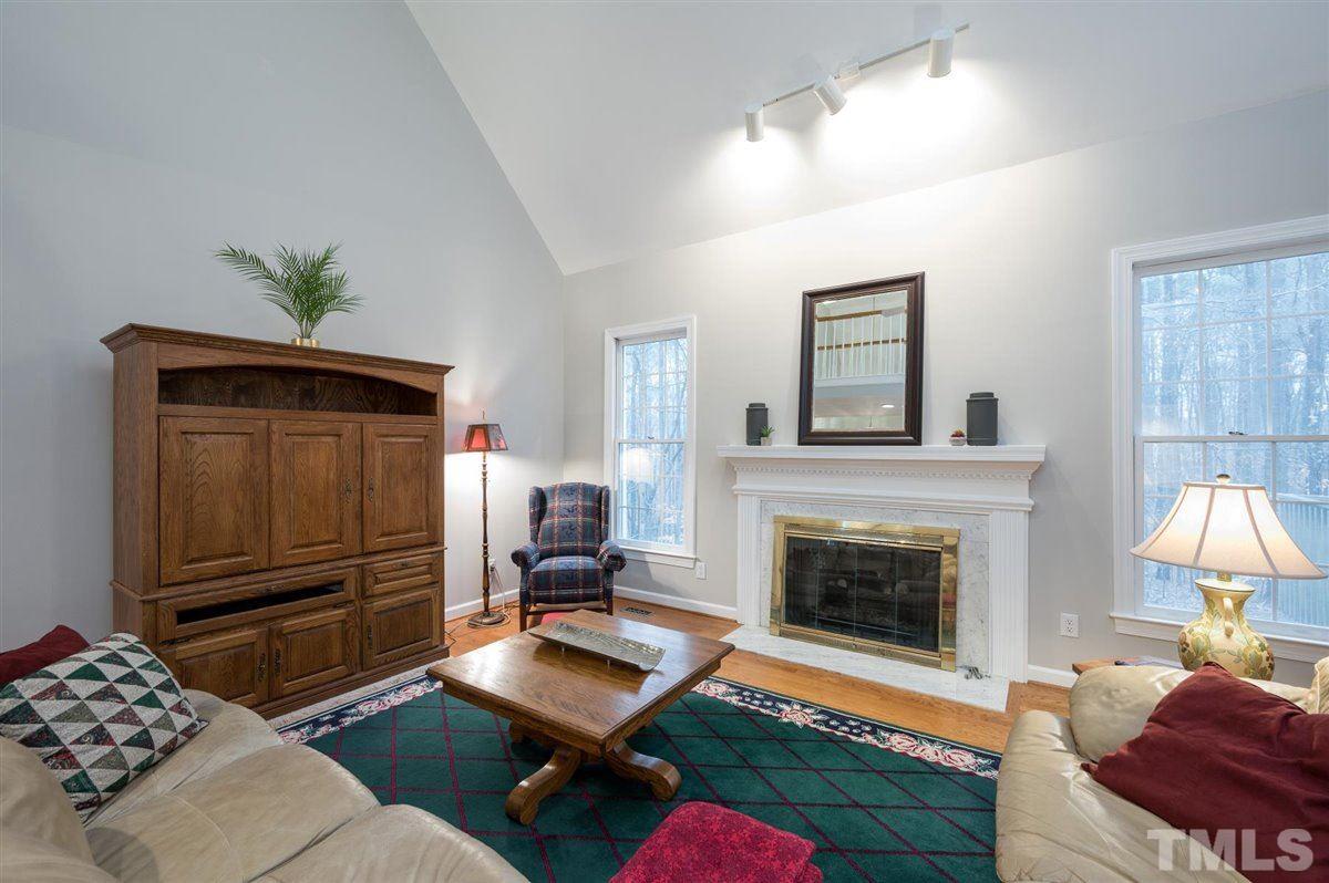 5704 Dunstan Court Raleigh, NC 27613 - Photo 9 of 23 a living room with furniture and a fireplace