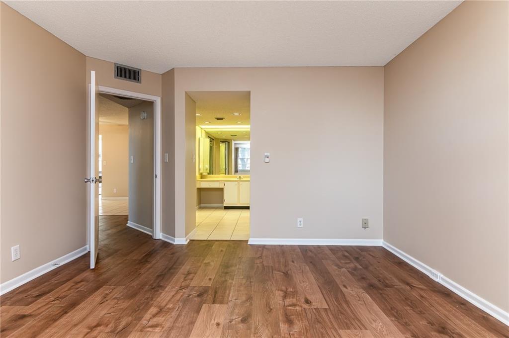 1601 Abaco Drive, Unit D1 Coconut Creek, FL 33066 - Photo 11 of 25 wooden floor in an empty room