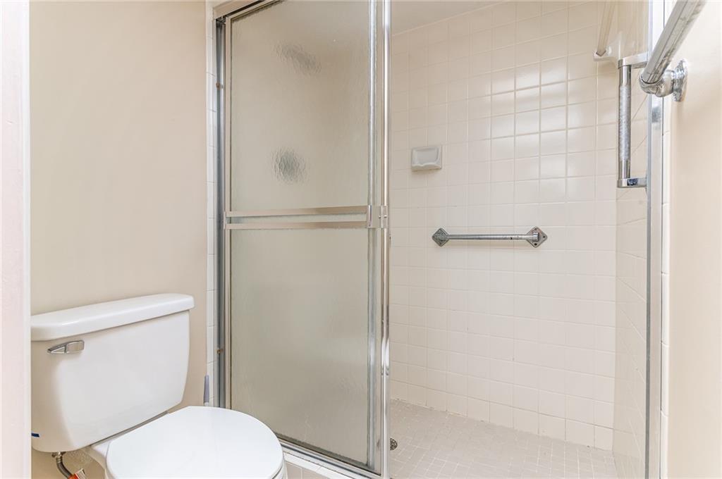 1601 Abaco Drive, Unit D1 Coconut Creek, FL 33066 - Photo 14 of 25 a white toilet next to a bathroom