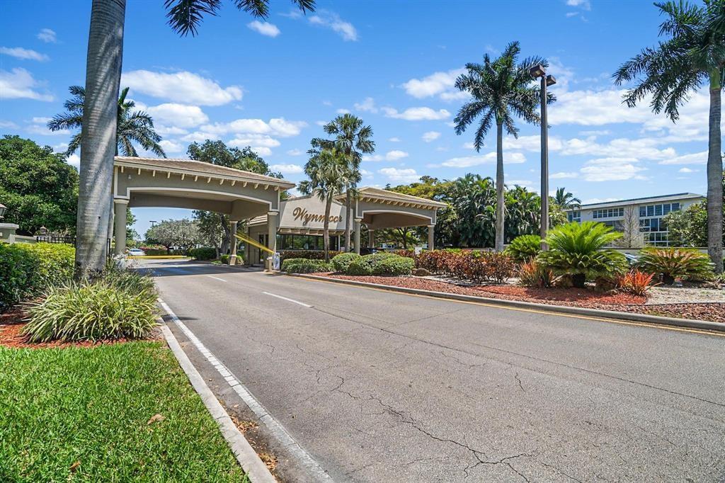 1601 Abaco Drive, Unit D1 Coconut Creek, FL 33066 - Photo 22 of 25 front view of a house with a yard and palm trees
