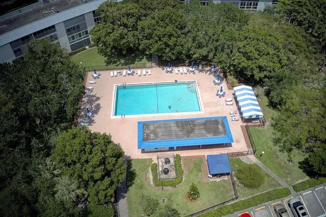 an aerial view of a residential houses with yard