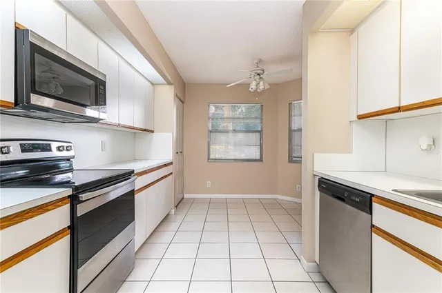 a kitchen with stainless steel appliances granite countertop a sink and a stove