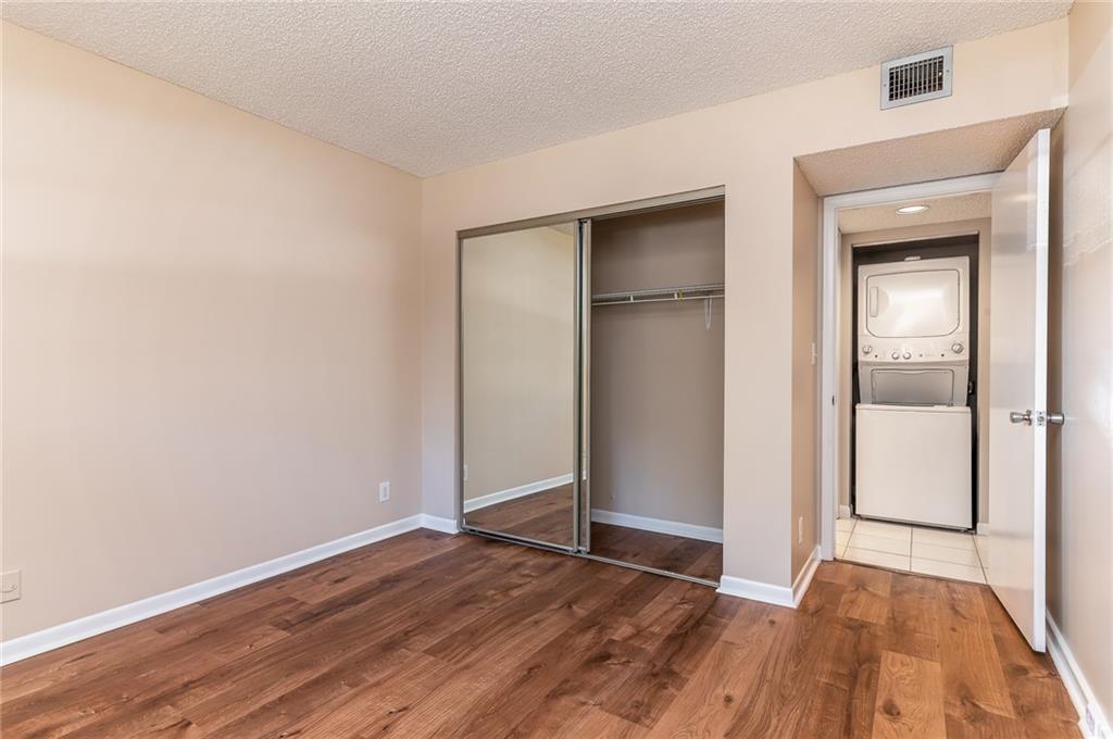 1601 Abaco Drive, Unit D1 Coconut Creek, FL 33066 - Photo 9 of 25 an empty room with wooden floor and closet