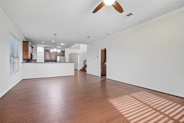 a view of a kitchen with a dishwasher and wooden floor