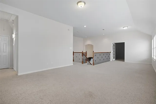 an empty room with furniture and a flat screen tv