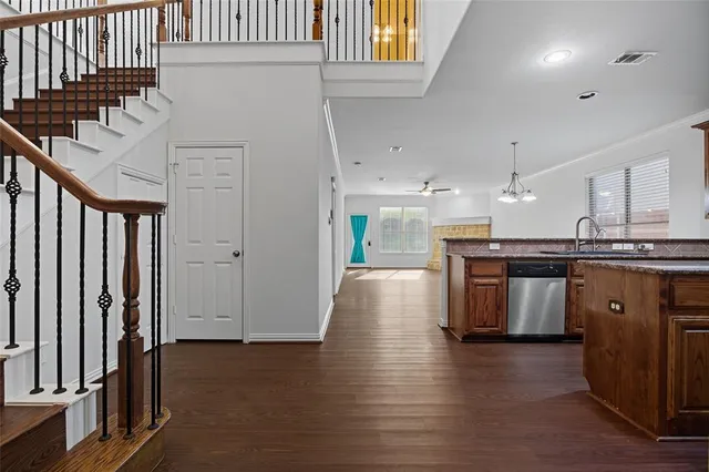 a kitchen with stainless steel appliances granite countertop a refrigerator a sink and a stove