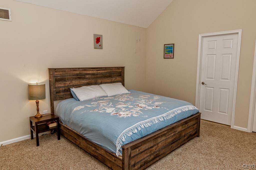 973 Renaldi Road Wind Gap, PA 18091 - Photo 24 of 50 a bed sitting in a bedroom next to a lamp