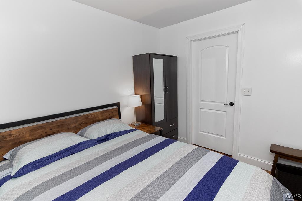 973 Renaldi Road Wind Gap, PA 18091 - Photo 42 of 50 a bedroom with a bed and wooden floor