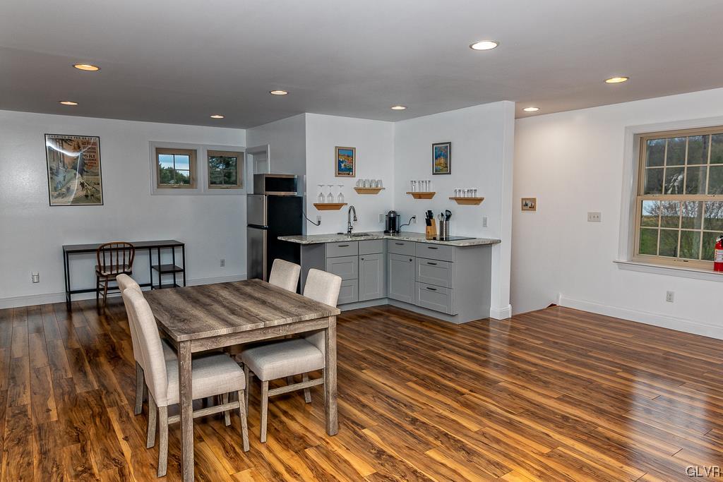 973 Renaldi Road Wind Gap, PA 18091 - Photo 44 of 50 a kitchen with stainless steel appliances kitchen island granite countertop a table chairs sink and cabinets